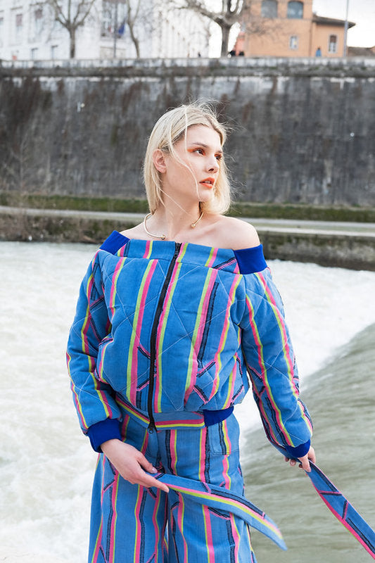 KARDASCIAN (off-shoulder kilted bomber jacket in kente)