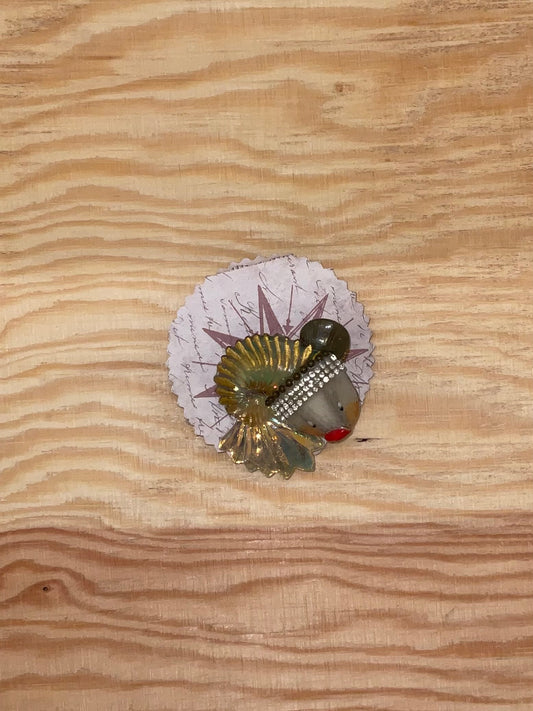 Decorative item with a fish design on a wooden surface