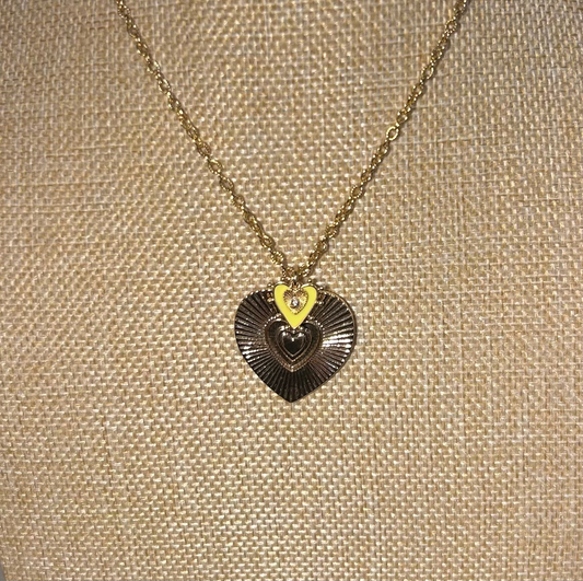 Necklace with a heart-shaped pendant on a beige textured background