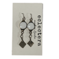 A pair of silver-toned dangle earrings with oval white stones and dangling square charms, displayed on a white card printed with the brand name 'eclectera'.