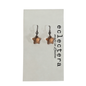 A pair of star-shaped drop earrings with dark metal hooks and a warm copper or rose-gold toned center, displayed on a white card printed with the brand name 'eclectera made in London'.