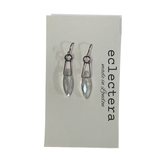 A pair of silver-toned drop earrings with clear faceted teardrop crystals, displayed on a white brand card for 'eclectera made in London'.