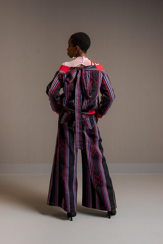KARDASCIAN (off-shoulder kilted bomber jacket in kente)