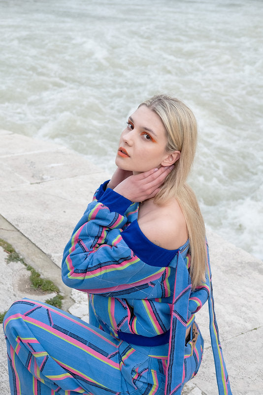 KARDASCIAN (off-shoulder kilted bomber jacket in kente)