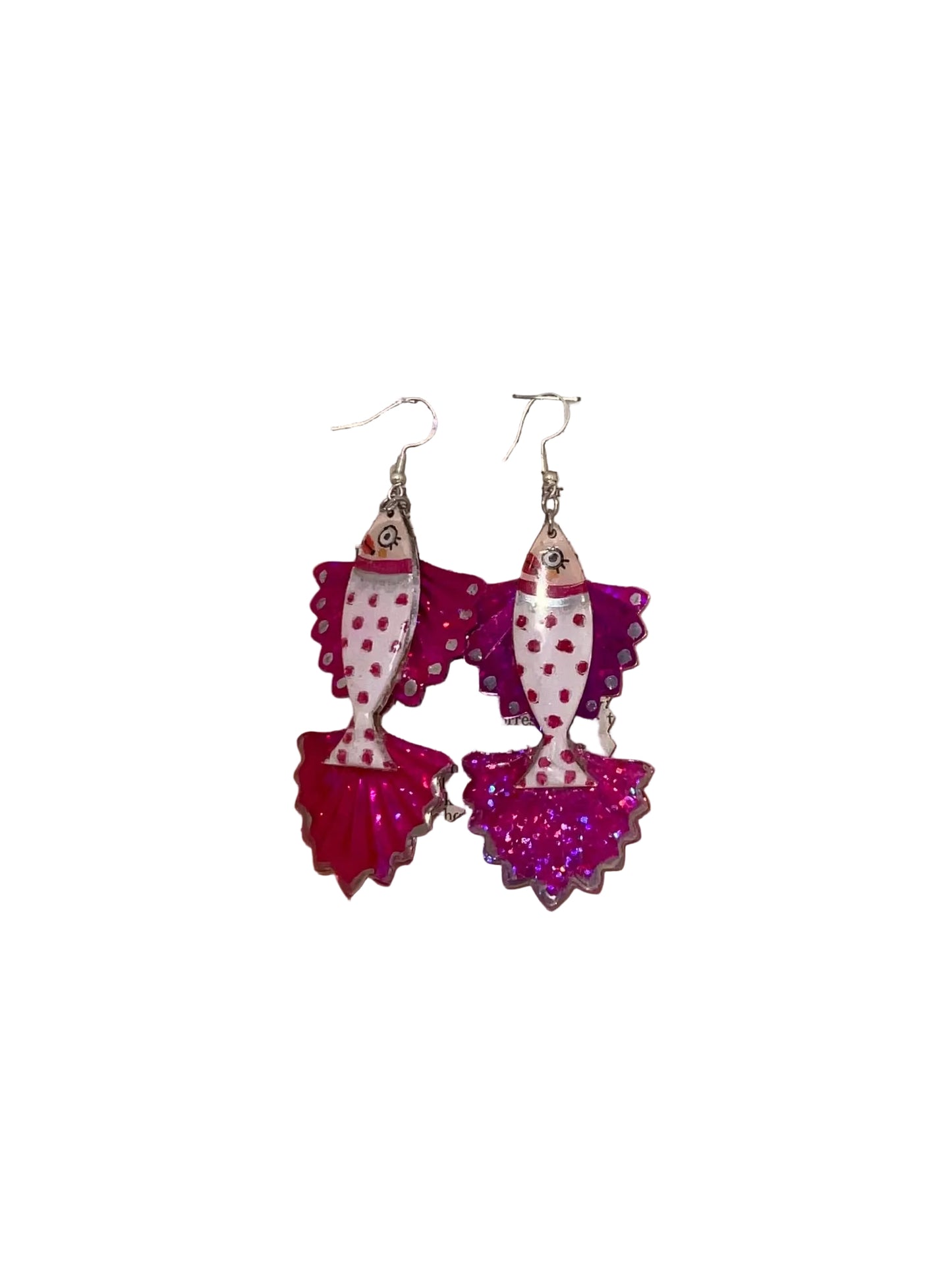 Decorative earrings with polka dot design on a wooden surface