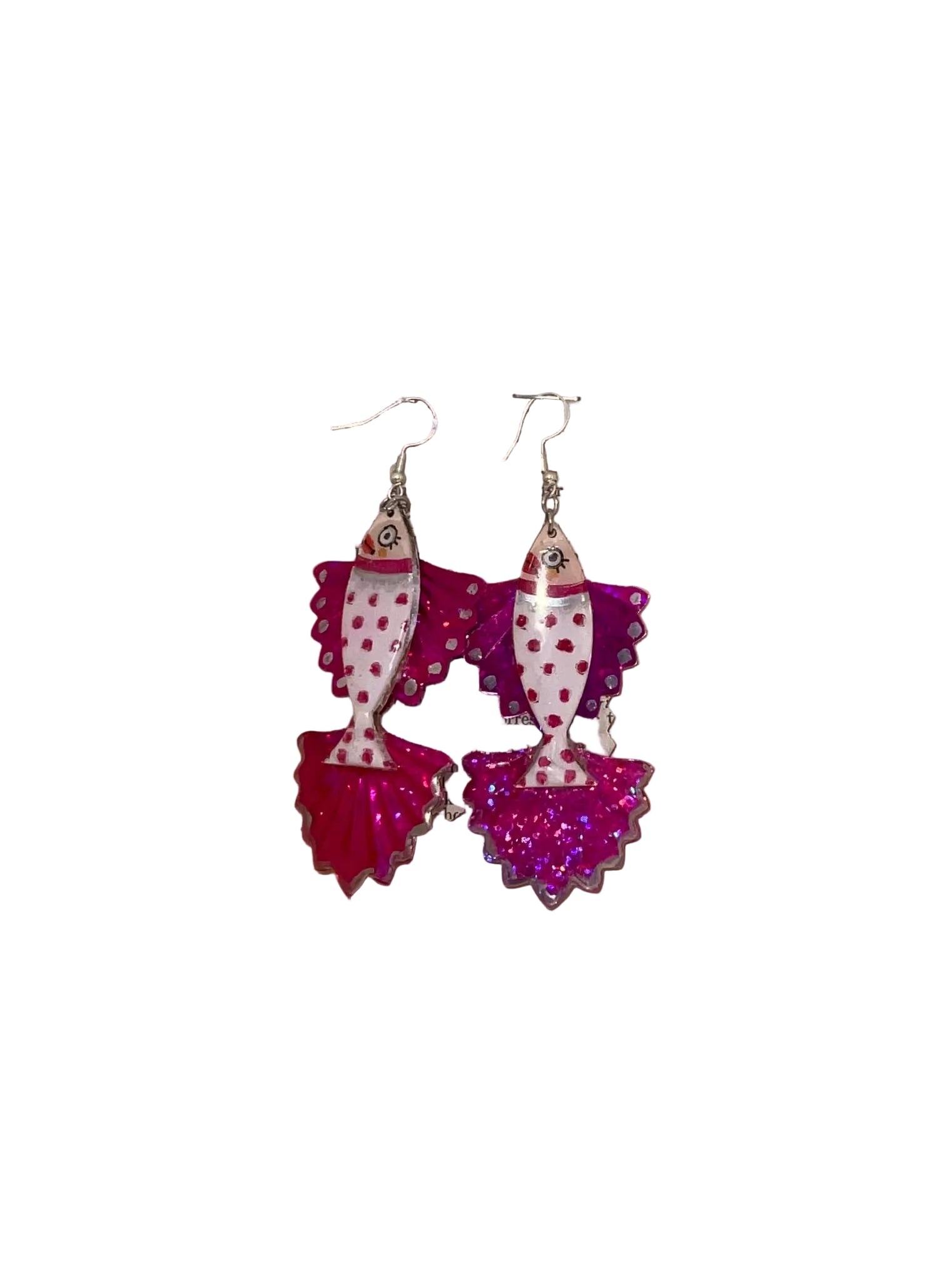 Decorative earrings with polka dot design on a wooden surface