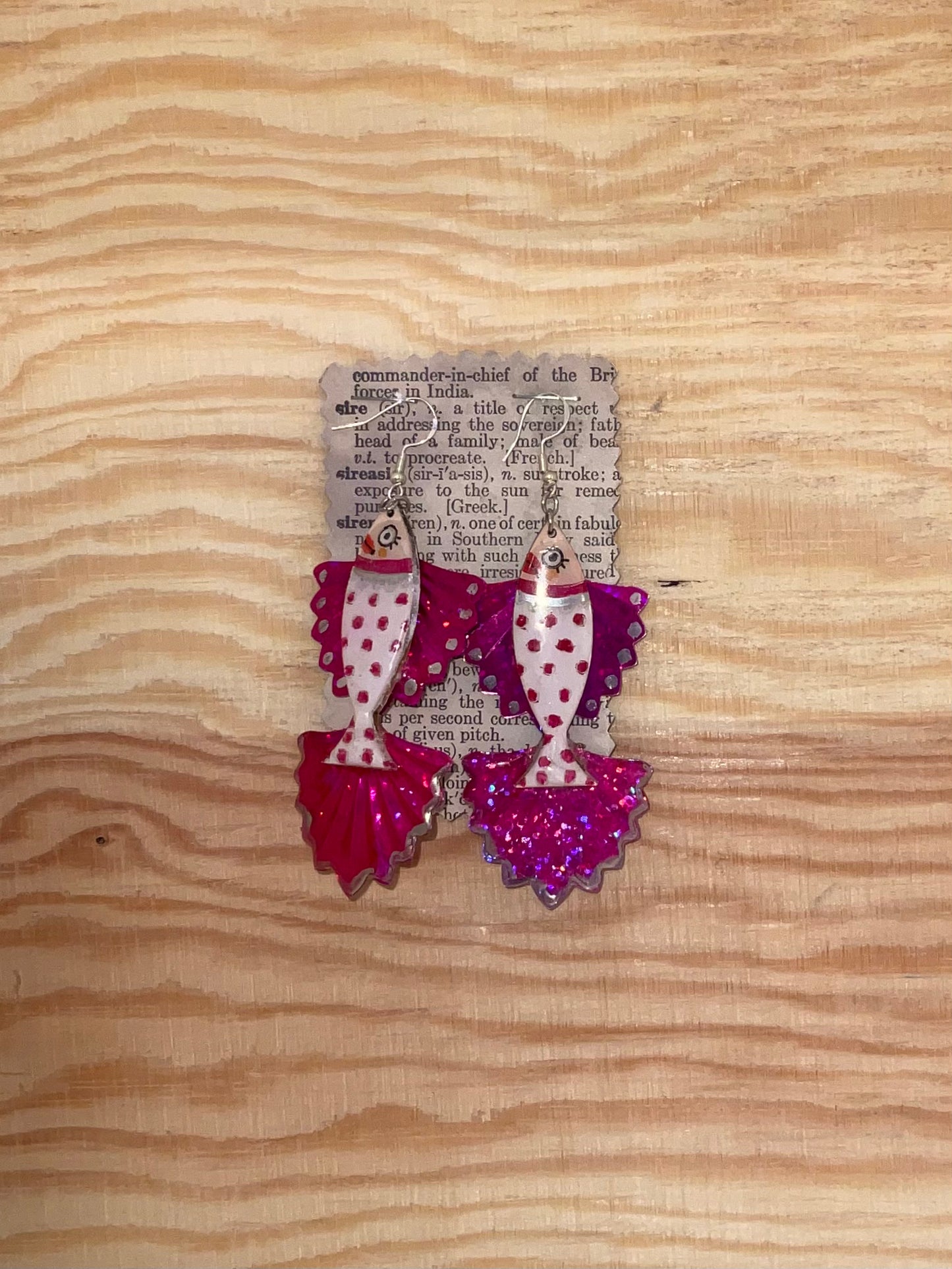 Decorative earrings with polka dot design on a wooden surface