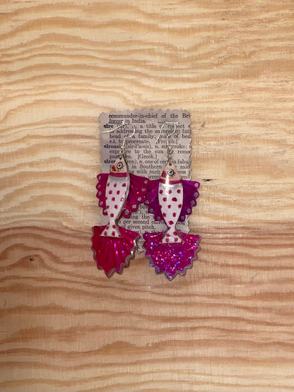 Decorative earrings with polka dot design on a wooden surface