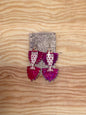 Decorative earrings with polka dot design on a wooden surface