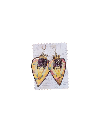 Heart-shaped earrings with artistic design on a wooden surface
