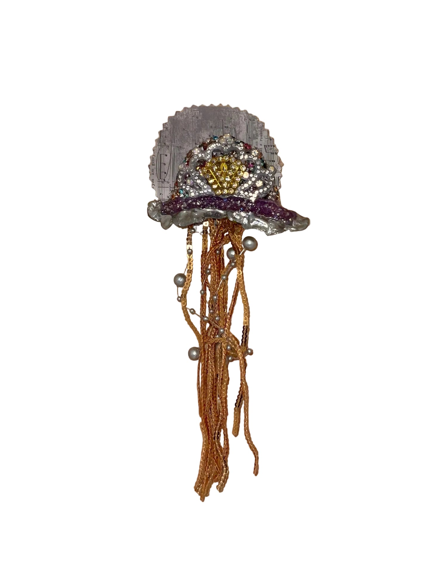 Decorative brooch with beads on a wooden surface