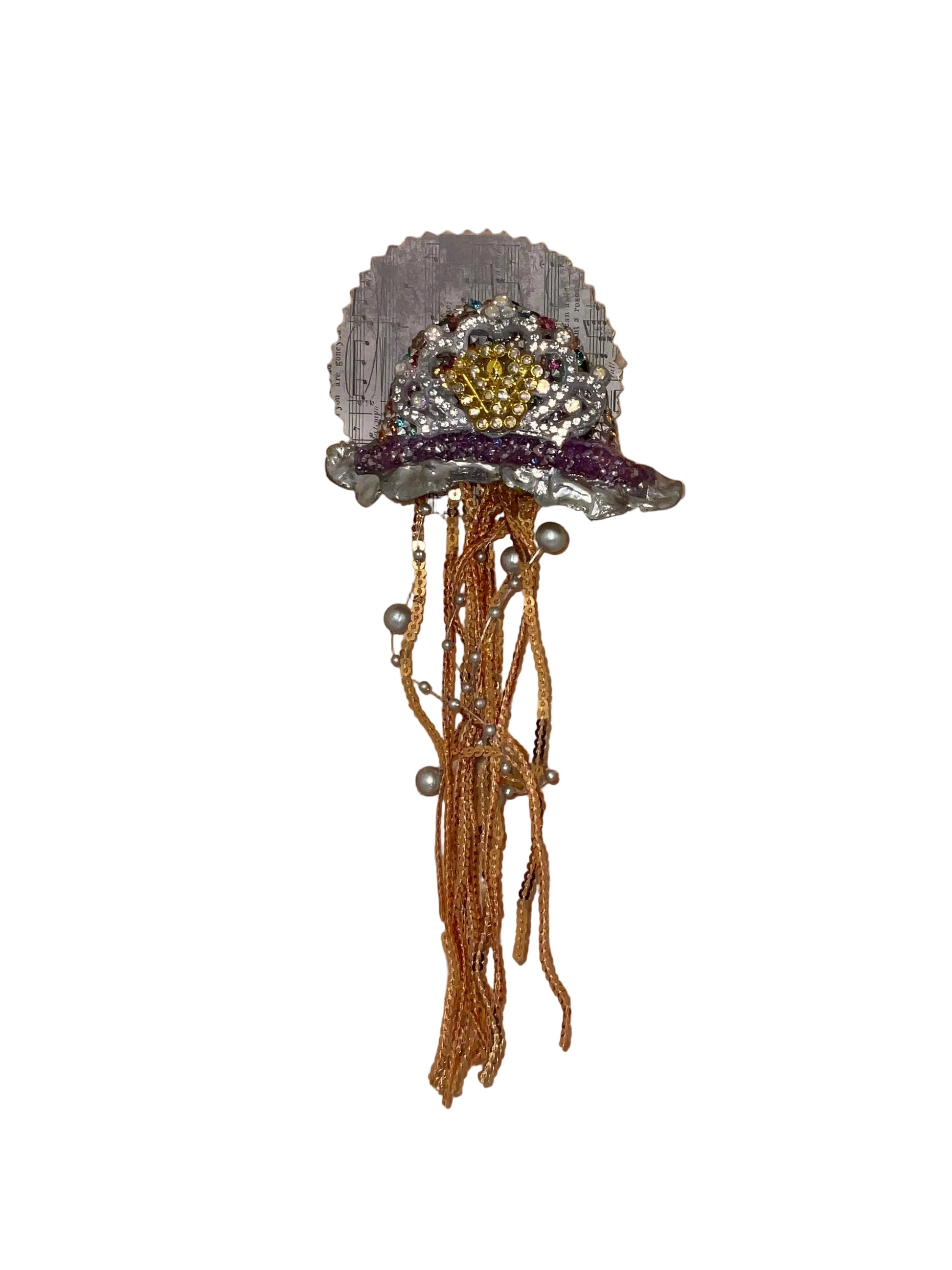 Decorative brooch with beads on a wooden surface