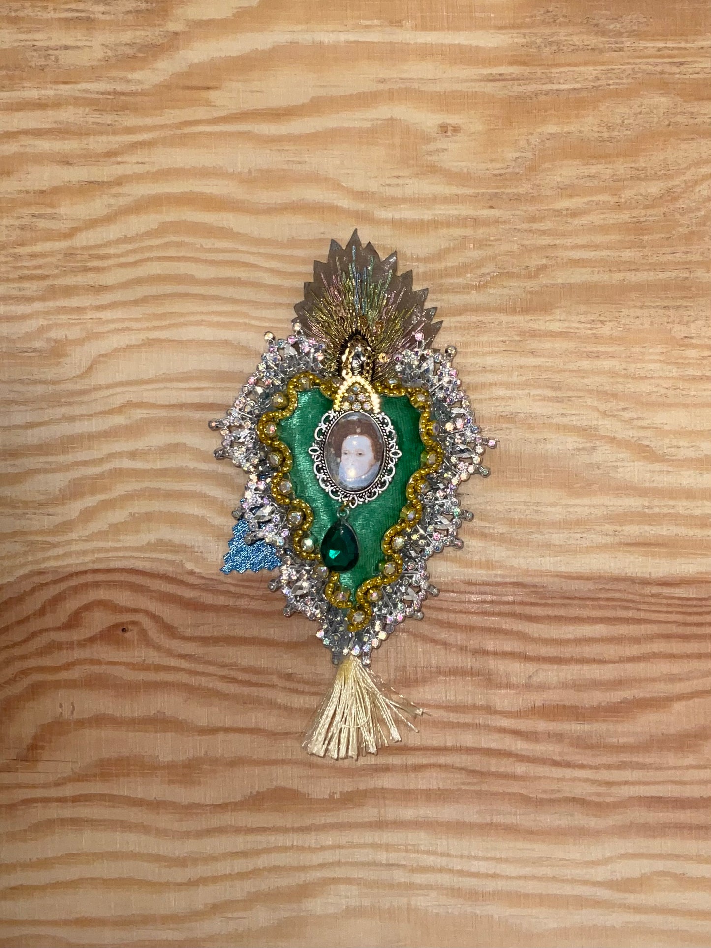 Decorative brooch with portrait on a wooden surface