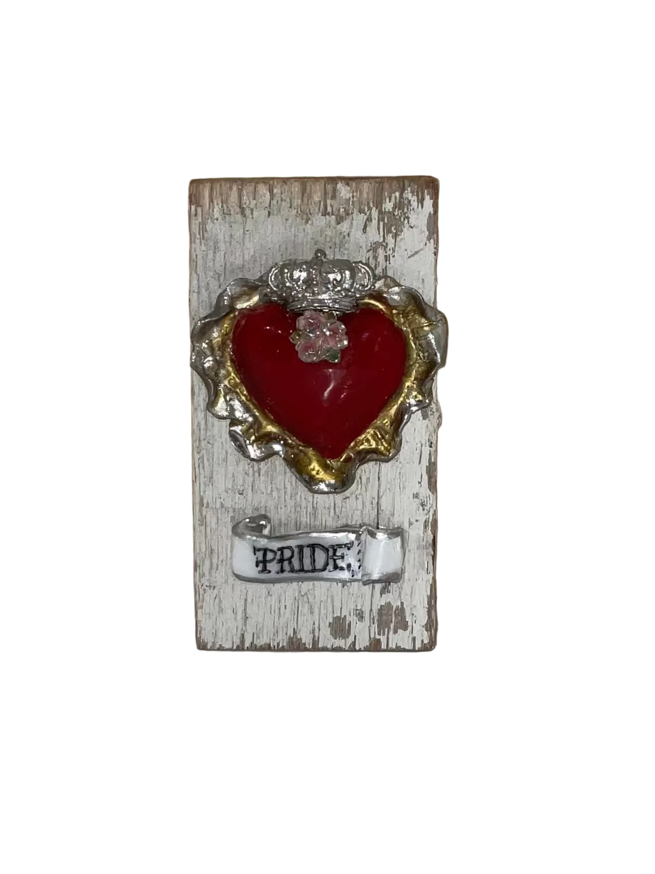 Decorative heart with 'Pride' text on a wooden block