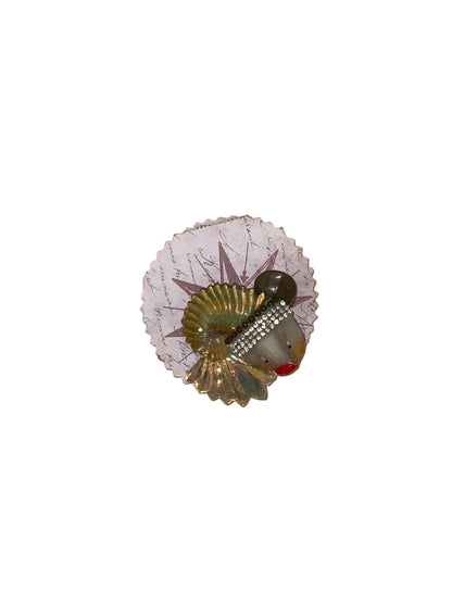 Decorative item with a fish design on a wooden surface