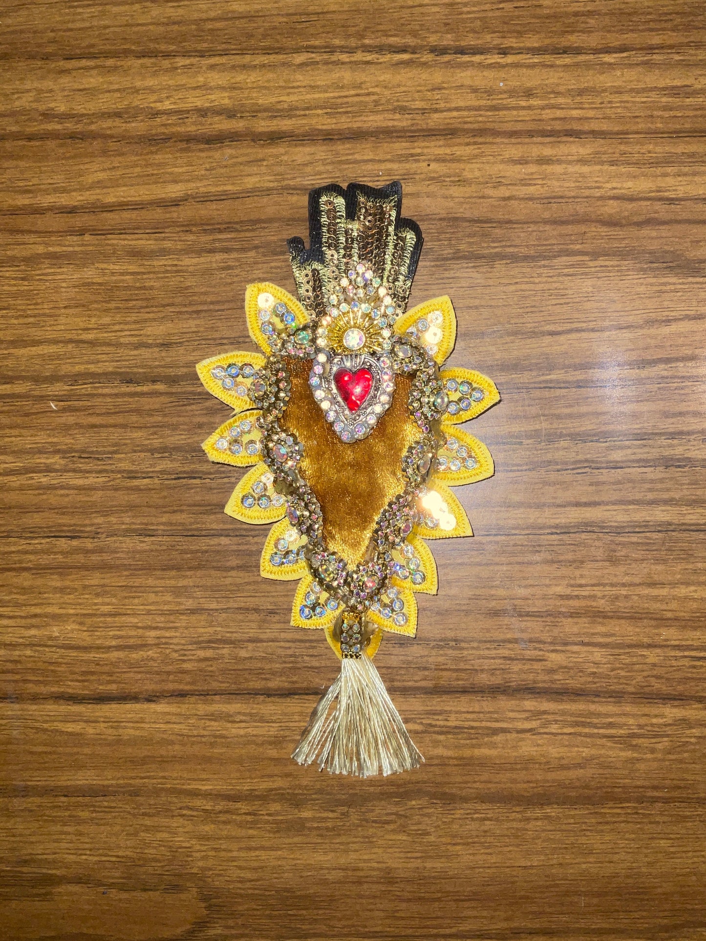 Decorative hair clip with intricate design on a wooden surface