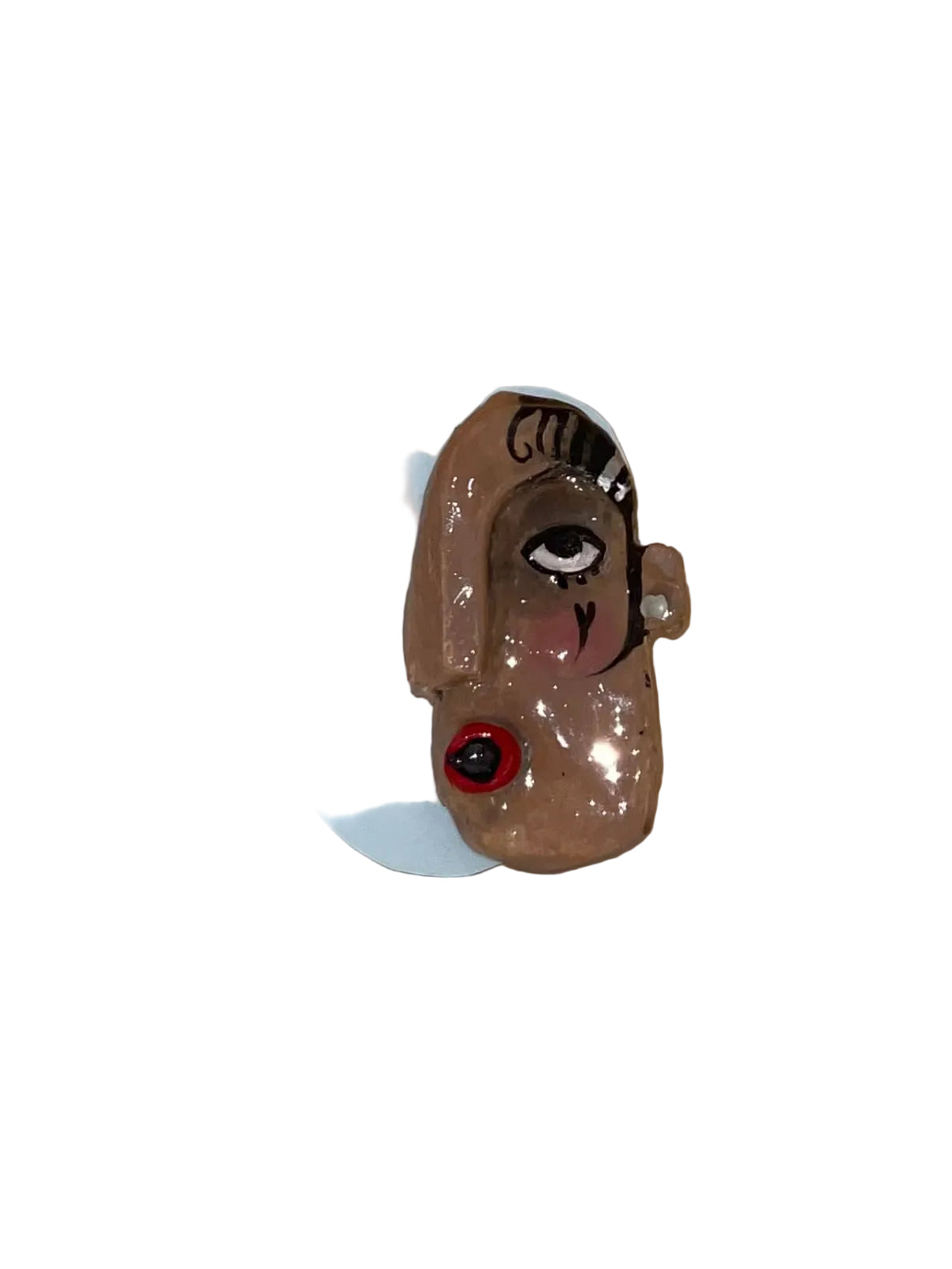 Small figurine of a dog with a white base on a wooden surface