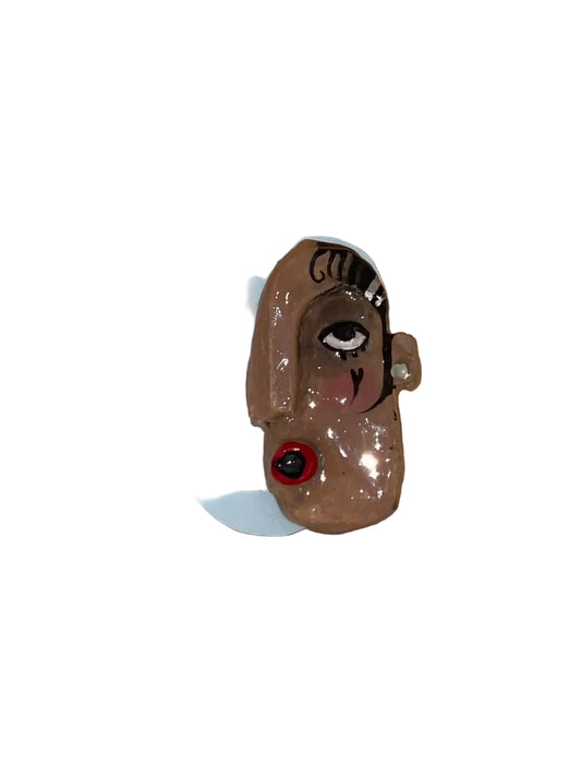 Small figurine of a dog with a white base on a wooden surface