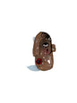 Small figurine of a dog with a white base on a wooden surface