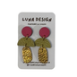 A pair of handmade dangle earrings by Luna Design, featuring a magenta pink circle, a textured olive green semicircle, and a hammered gold textured drop, displayed on a white backing card.