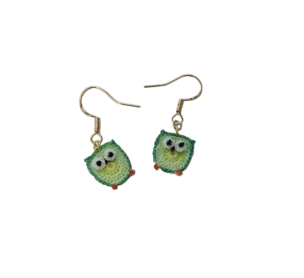 Green owl-shaped earrings on a white background