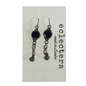 A pair of gothic-style dangle earrings with dark round stones and silver-toned chains, displayed on a white card printed with the brand name 'eclectera made in London'.