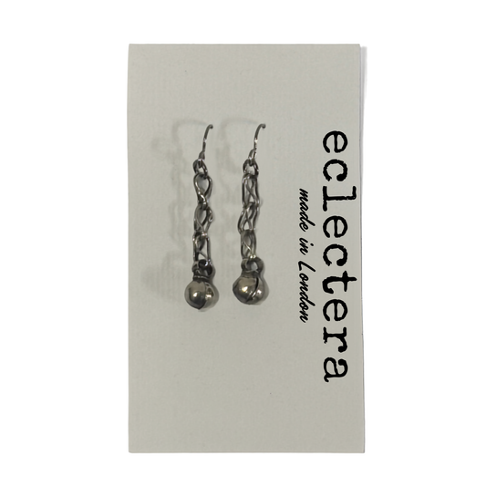 A pair of silver-toned dangle earrings with chain links and small spherical charms, displayed on a white card printed with the brand name 'eclectera made in London'.