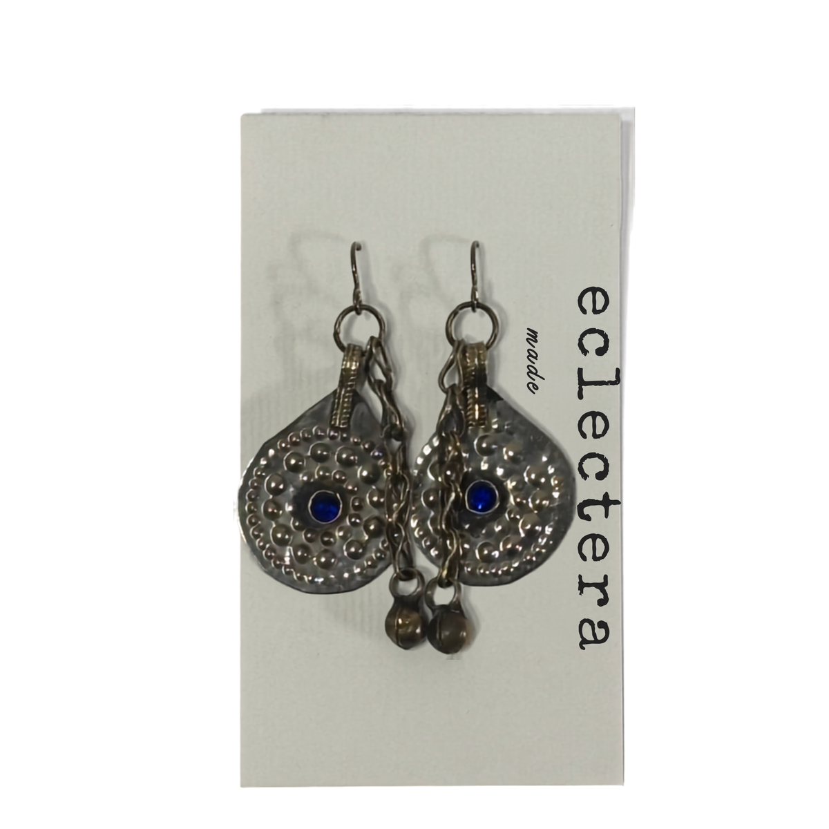 A pair of silver-toned teardrop dangle earrings with blue evil eye stones and small hanging beads, displayed on a white card labeled 'eclectera'.