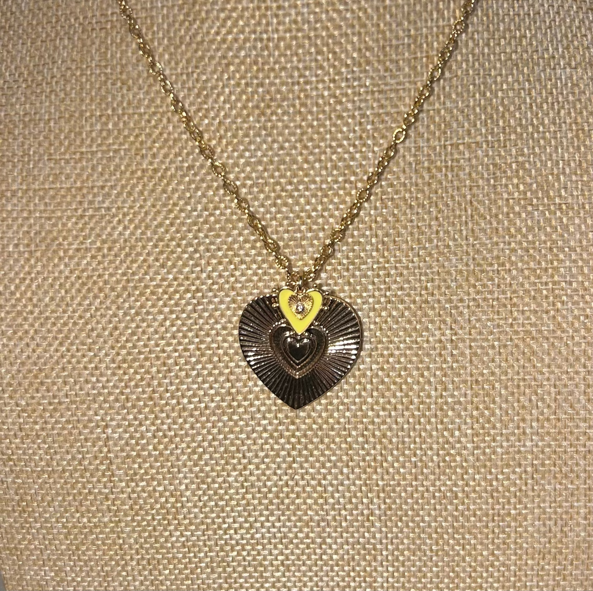 Necklace with a heart-shaped pendant on a beige textured background