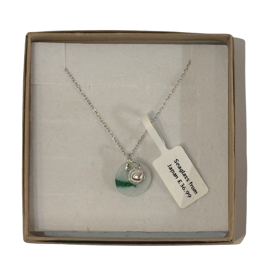 A frosted piece of glass collected from Japan, paired with a sterling silver shell hung on a sterling silver 18 inch belcher chain.