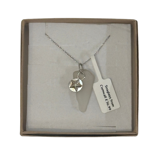 A frosted piece of glass collected from Cornwall, paired with a sterling silver starfish hung on a sterling silver 18 inch belcher chain.
