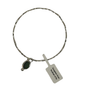 A silver-toned bangle bracelet with a small oval dark green stone charm and a white paper tag attached, shown on a plain white background.