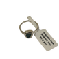 A silver ring with a triangular dark green stone, attached to a white paper tag that reads 'Seaglass from Brighton.