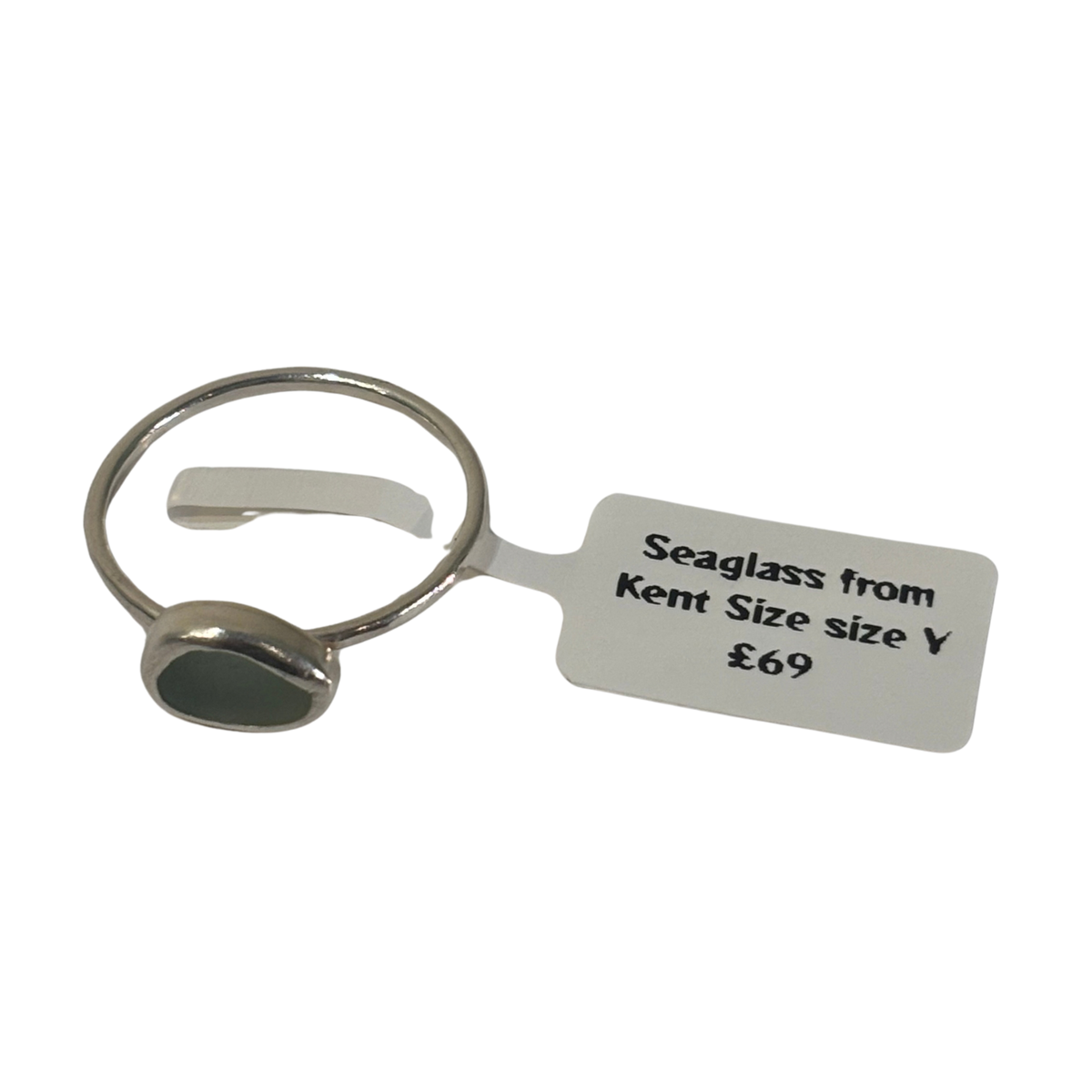 A silver-toned metal ring with a small oval seaglass stone, shown with a white paper tag that reads 'Seaglass from Kent Size size Y £69' on a plain white background.