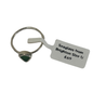 A silver-toned seaglass ring with a small triangular green stone, shown with a white paper size tag that reads 'Seaglass from Brighton Size U £69' on a plain white background.