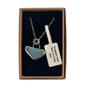 A silver necklace with a sea glass pendant and a small aqua stone set in sterling silver with a granulation and finished to an high shine, presented in a brown gift box.