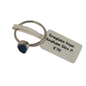 A silver-toned ring with a small oval blue seaglass stone, attached to a white paper tag that reads 'Seaglass from Seaham Size P £70' on a plain white background.