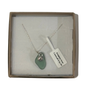 A frosted piece of green glass with collected from Cornwall, paired with a sterling silver shell hung on a sterling silver 18 inch belcher chain.