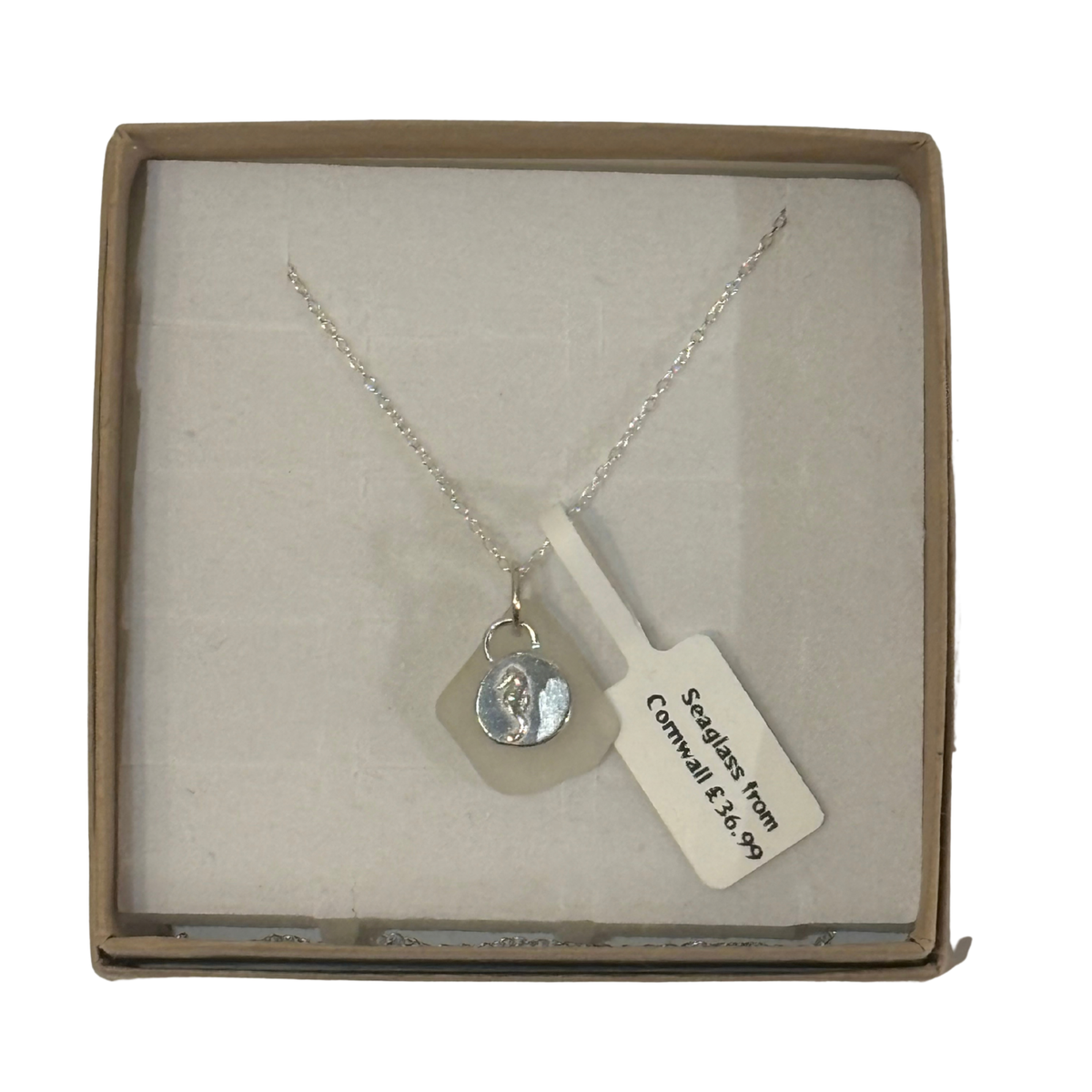 A frosted piece of white glass with collected from Cornwall, paired with a sterling silver seahorse hung on a sterling silver 18 inch belcher chain.