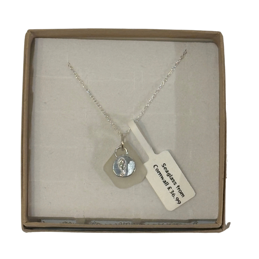 A frosted piece of white glass with collected from Cornwall, paired with a sterling silver seahorse hung on a sterling silver 18 inch belcher chain.