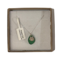 A frosted piece of green glass with collected from Cornwall, paired with a sterling silver shell hung on a sterling silver 18 inch belcher chain.