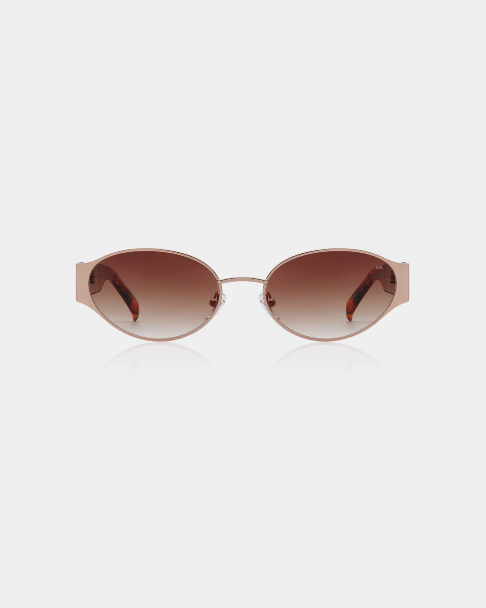 Sunglasses with a rose gold frame and brown gradient lenses on a white background