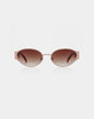 Sunglasses with a rose gold frame and brown gradient lenses on a white background